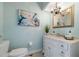 Elegant powder room with marble vanity and chandelier at 55 Edgewater Dr, Dunedin, FL 34698
