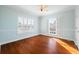Light-filled bedroom featuring hardwood floors and plantation shutters at 55 Edgewater Dr, Dunedin, FL 34698