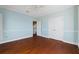 Bedroom with hardwood floors and access to upper level at 55 Edgewater Dr, Dunedin, FL 34698