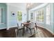 Bright dining room with bay window, hardwood floors, and modern dining set at 55 Edgewater Dr, Dunedin, FL 34698