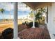 Brick porch with white columns, offering water views and a relaxing atmosphere at 55 Edgewater Dr, Dunedin, FL 34698