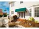 Front entrance with green awning and brick steps at 55 Edgewater Dr, Dunedin, FL 34698