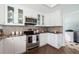 Bright kitchen with stainless steel appliances and white cabinets at 55 Edgewater Dr, Dunedin, FL 34698