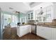 Open kitchen features granite countertops and white cabinets at 55 Edgewater Dr, Dunedin, FL 34698
