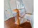 Elegant staircase with wood railings and hardwood floors at 55 Edgewater Dr, Dunedin, FL 34698