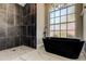 Modern bathroom with walk-in shower and freestanding tub at 6210 68Th E Dr, Palmetto, FL 34221