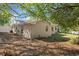 Backyard view of house with trees at 7145 Abigail Dr, Port Richey, FL 34668