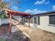 Relaxing backyard patio with pergola and stone pavers at 7824 Hawthorn Dr, Port Richey, FL 34668