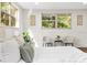 Sitting area in a bedroom with two chairs, rug, and window with greenery view at 807 E Genesee St # 1/2, Tampa, FL 33603