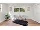 Bedroom corner with two chairs and a black rug, natural light from window at 807 E Genesee St # 1/2, Tampa, FL 33603
