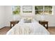 Close-up of bed with white sheets and pillows in a bright bedroom at 807 E Genesee St # 1/2, Tampa, FL 33603