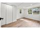 Bright bedroom with wood-look floors, white walls, and closet at 807 E Genesee St # 1/2, Tampa, FL 33603