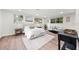 Bedroom featuring wood-look floors, white walls, large bed, and windows at 807 E Genesee St # 1/2, Tampa, FL 33603