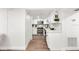 Modern white kitchen with stainless steel appliances and quartz countertops at 807 E Genesee St # 1/2, Tampa, FL 33603