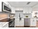 Bright, modern kitchen with white cabinetry, stainless steel appliances, and quartz countertops at 807 E Genesee St # 1/2, Tampa, FL 33603