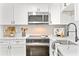 Updated kitchen featuring white shaker cabinets, stainless steel appliances, and subway tile backsplash at 807 E Genesee St # 1/2, Tampa, FL 33603