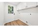 Laundry room with white cabinets, washer/dryer hookups, and exterior access at 807 E Genesee St # 1/2, Tampa, FL 33603