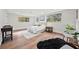 Main bedroom with wood floors, windows, and a cozy sitting area at 807 E Genesee St # 1/2, Tampa, FL 33603