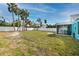 Large grassy backyard with screened porch at 815 Lantana Ave, Clearwater Beach, FL 33767