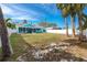 Backyard view of a teal house with a screened porch at 815 Lantana Ave, Clearwater Beach, FL 33767