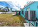 Backyard view of teal house and AC unit at 815 Lantana Ave, Clearwater Beach, FL 33767