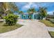 Beautiful teal home with palm trees and a brick driveway at 815 Lantana Ave, Clearwater Beach, FL 33767