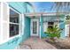 House exterior with teal walls, white shutters, and a striped awning at 815 Lantana Ave, Clearwater Beach, FL 33767