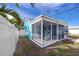 Screened porch with seating area, offering outdoor space at 815 Lantana Ave, Clearwater Beach, FL 33767