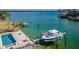 Luxury waterfront property featuring a private boat lift and inviting pool at 835 119Th Ave, Treasure Island, FL 33706