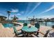 Waterfront patio with table and chairs, offering stunning views at 835 119Th Ave, Treasure Island, FL 33706