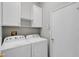 Laundry room with washer, dryer, and shelving at 11228 Bloomington Dr, Tampa, FL 33635