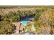 Aerial view of community pool, shuffleboard, and lake at 11616 Baywood Meadows Dr # 7, New Port Richey, FL 34654