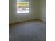 Bright bedroom with neutral carpeting and large window at 11616 Baywood Meadows Dr # 7, New Port Richey, FL 34654