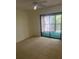 Bedroom with carpet and sliding glass doors to balcony at 11616 Baywood Meadows Dr # 7, New Port Richey, FL 34654