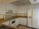 Kitchen with white cabinets, wood countertops, and appliances at 11616 Baywood Meadows Dr # 7, New Port Richey, FL 34654