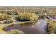 Aerial view of community lake with fountain and homes at 11616 Baywood Meadows Dr # 7, New Port Richey, FL 34654