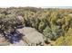 Aerial view of tennis court nestled in wooded area at 11616 Baywood Meadows Dr # 7, New Port Richey, FL 34654