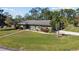 Single story home, large yard, and circular driveway at 1242 Holiday Dr, Tarpon Springs, FL 34689