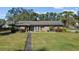 Exterior view of the house with landscaping and walkway at 1242 Holiday Dr, Tarpon Springs, FL 34689