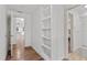 Bright hallway with built-in shelves and wood floors at 1242 Holiday Dr, Tarpon Springs, FL 34689