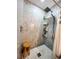 Updated shower with marble tile, glass enclosure, and built-in shelves at 1275 Mission Cir # 50-A, Clearwater, FL 33759