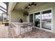 Outdoor kitchen with granite countertop, built-in grill, and seating for multiple people at 17811 Howsmoor Pl, Lutz, FL 33559