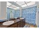 Bathroom with double vanity and blue floral shower curtain at 1998 Massachusetts Ne Ave, St Petersburg, FL 33703