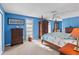 Main bedroom with blue walls and wooden furniture at 1998 Massachusetts Ne Ave, St Petersburg, FL 33703