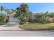 Single story home with attached garage and mature landscaping at 1998 Massachusetts Ne Ave, St Petersburg, FL 33703