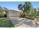 Single story home with attached garage and mature landscaping at 1998 Massachusetts Ne Ave, St Petersburg, FL 33703
