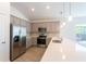 Modern kitchen with stainless steel appliances and gray cabinets at 20118 Quesada Ave, Port Charlotte, FL 33952