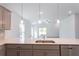 Kitchen island with white quartz countertops and modern pendant lighting at 20118 Quesada Ave, Port Charlotte, FL 33952