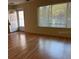 Bright living room with wood flooring and large window at 2021 Australia W Way # 17, Clearwater, FL 33763