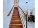 Elegant wooden staircase leading to upper level at 21914 Butterfly Kiss Dr, Land O Lakes, FL 34637